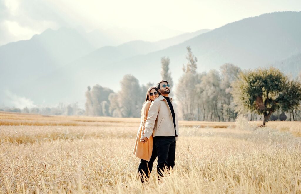 Couple embracing at sunrise in an open field