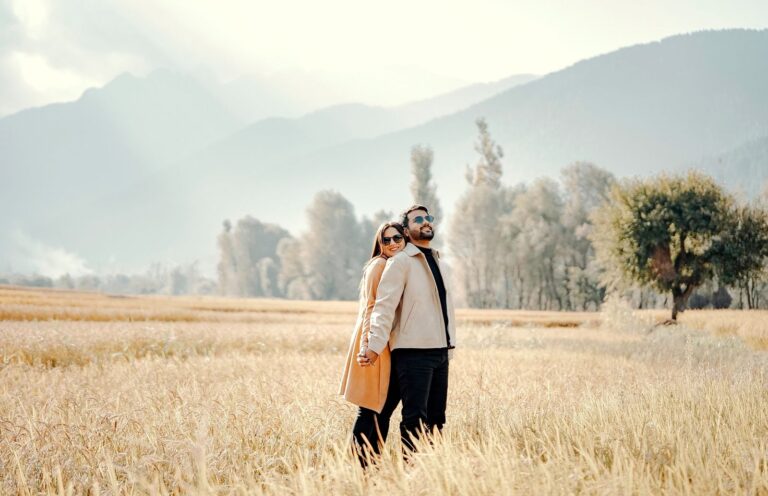 Couple embracing at sunrise in an open field